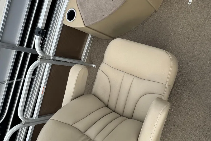 Slide: The Image of Beige captain's chair on 2012 Bennington 24 SF boat, with cup holder and storage. - 7