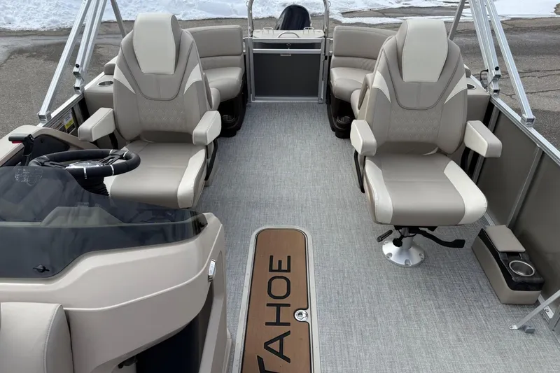 Slide: The Image of 2025 Tahoe 2185 boat interior with beige seating and steering wheel, showcasing luxury design. - 11