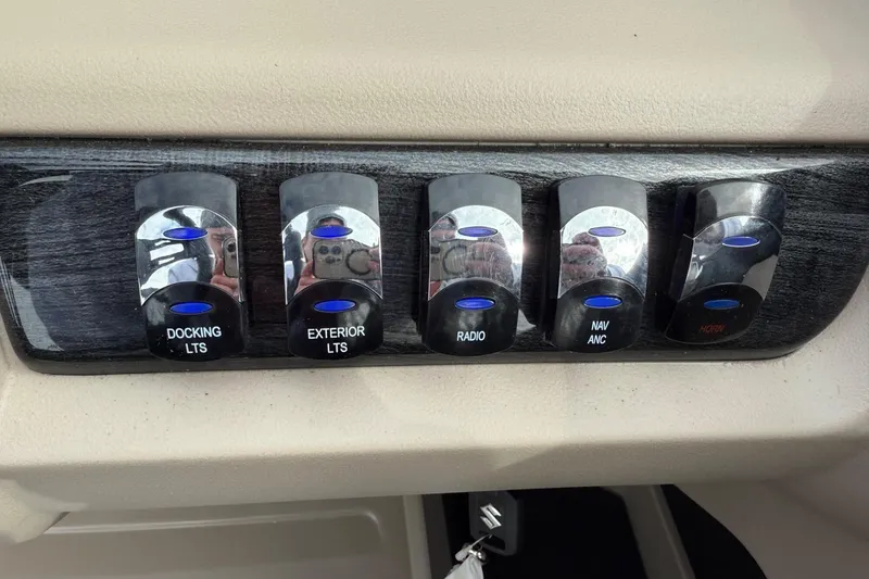 Slide: The Image of Control panel of 2025 Tahoe 2185 with switches for lights, radio, and navigation. - 17