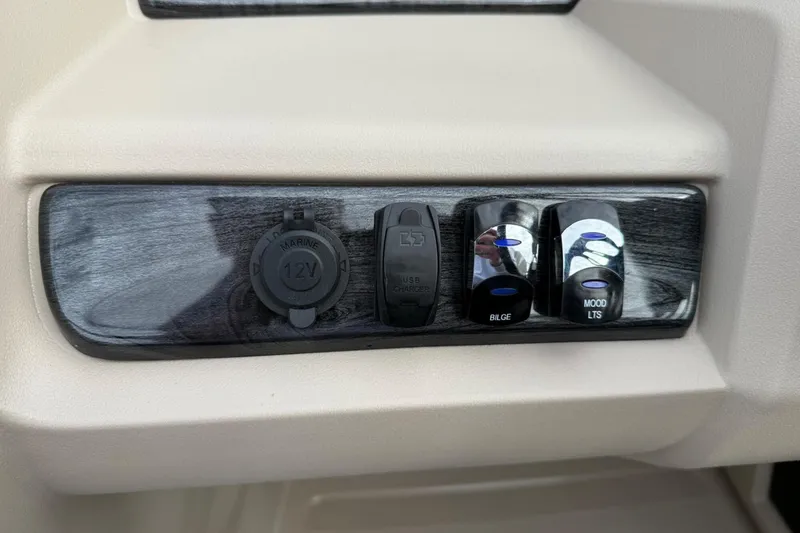Slide: The Image of Control panel of 2025 Tahoe 2185 with 12V outlet, USB charger, and switches. - 18