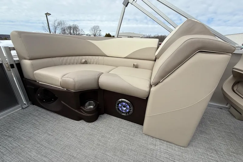 Slide: The Image of Luxurious seating on 2025 Tahoe 2185 boat, featuring beige upholstery and integrated speaker system. - 21