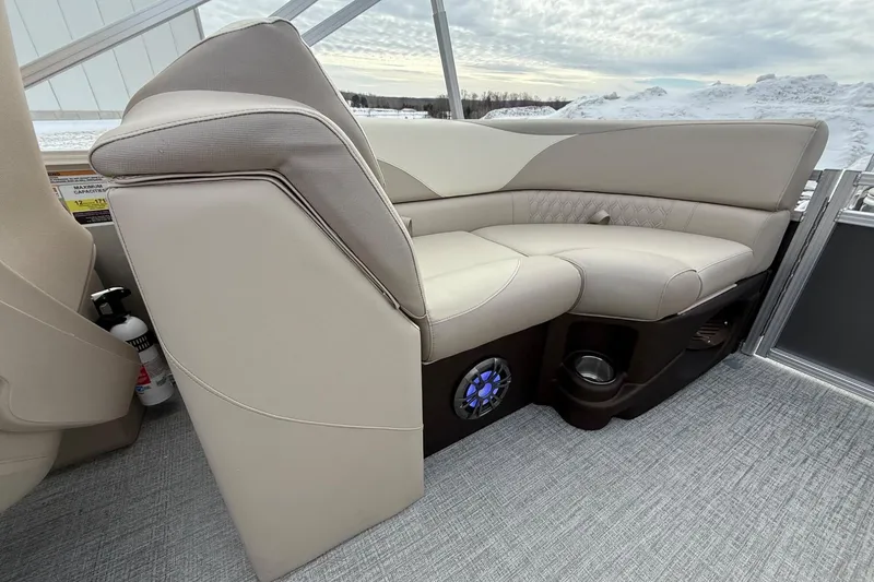 Slide: The Image of 2025 Tahoe 2185 boat interior with beige seating and built-in speaker. - 22