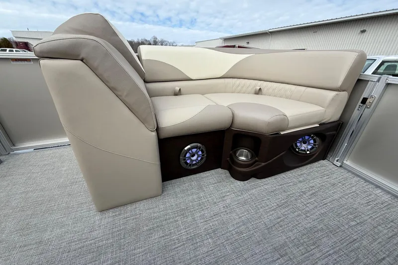 Slide: The Image of Luxurious seating on 2025 Tahoe 2185 boat with integrated speakers and cup holders. - 23