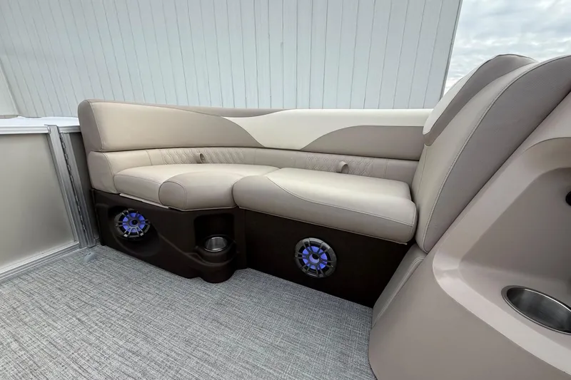 Slide: The Image of Luxurious seating in 2025 Tahoe 2185 boat with integrated speakers and cup holders. - 24