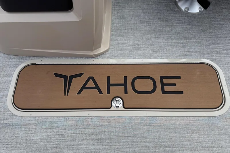Slide: The Image of 2025 Tahoe 2185 boat deck with logo on wooden panel. - 25