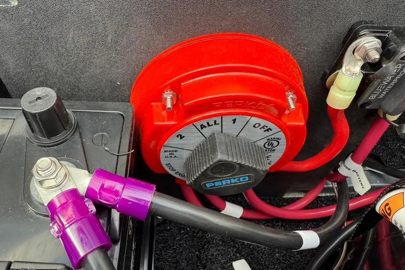 Slide: The Image of Red battery switch with cables in a 2025 Tahoe 2185 model. - 27