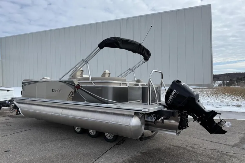 Slide: The Image of 2025 Tahoe 2185 pontoon boat with Suzuki outboard motor on a trailer. - 3