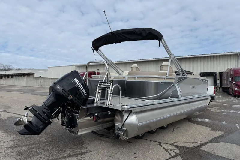 Slide: The Image of 2025 Tahoe 2185 pontoon boat with Suzuki outboard motor, parked outdoors. - 5