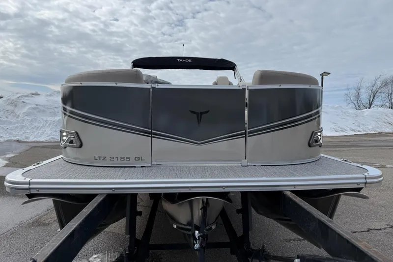 Slide: The Image of 2025 Tahoe 2185 pontoon boat on trailer, snowy background, overcast sky. - 8