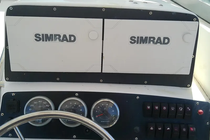 Slide: The Image of Throttle controls on a 2001 Boston Whaler 28 Outrage boat dashboard. - 16
