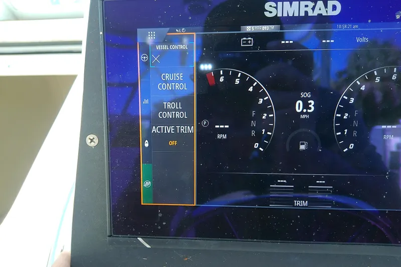 Slide: The Image of 2001 Boston Whaler 28 Outrage boat with open storage compartment and cup holder. - 18