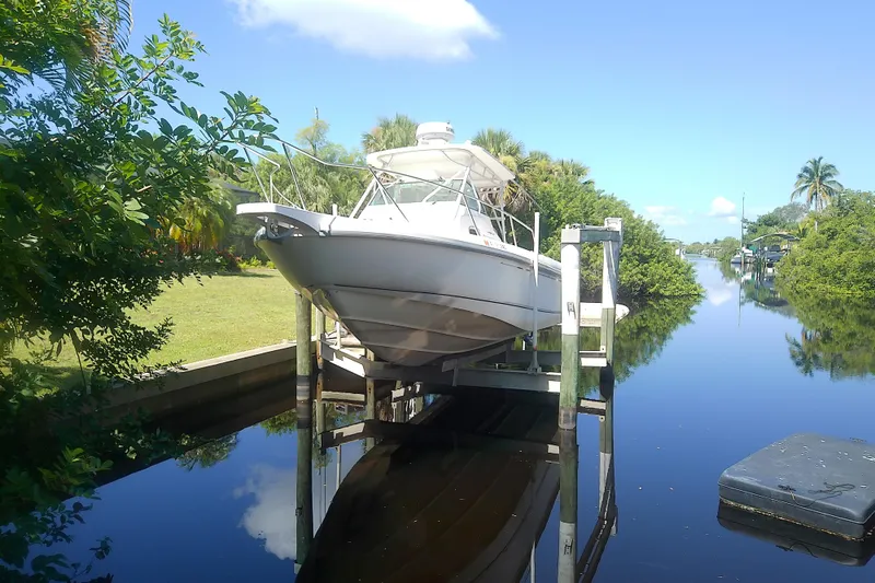 Slide: The Image of 2001 Boston Whaler 28 Outrage boat on trailer in marina setting. - 2