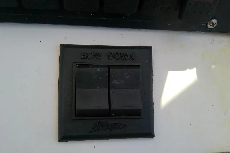 Slide: The Image of 2001 Boston Whaler 28 Outrage boat with white cushioned seats and steering wheel. - 24