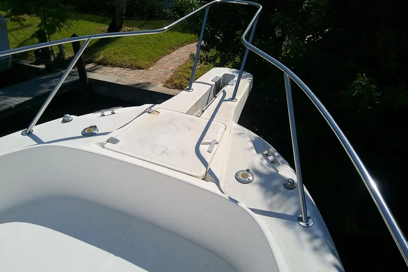 Slide: The Image of 2001 Boston Whaler 28 Outrage boat deck, parked on a trailer in a yard. - 28