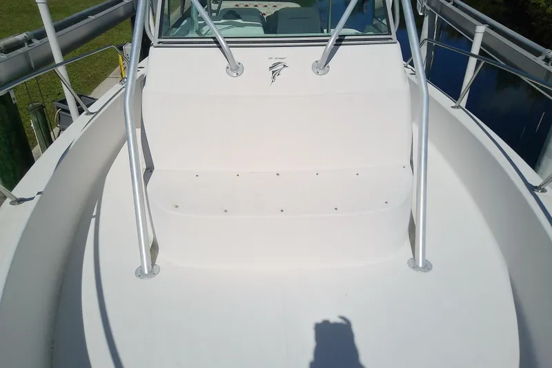 Slide: The Image of 2001 Boston Whaler 28 Outrage docked at marina with multiple boats. - 30