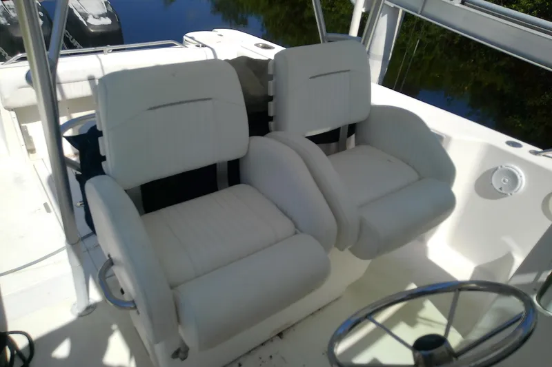 Slide: The Image of 2001 Boston Whaler 28 Outrage boat dashboard with control panel and storage compartment. - 34