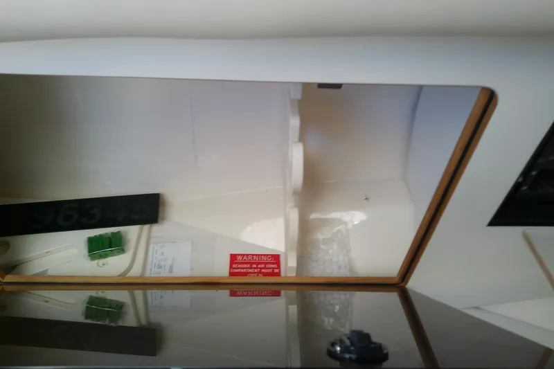 Slide: The Image of Microwave and control panel inside 2001 Boston Whaler 28 Outrage boat cabin. - 39