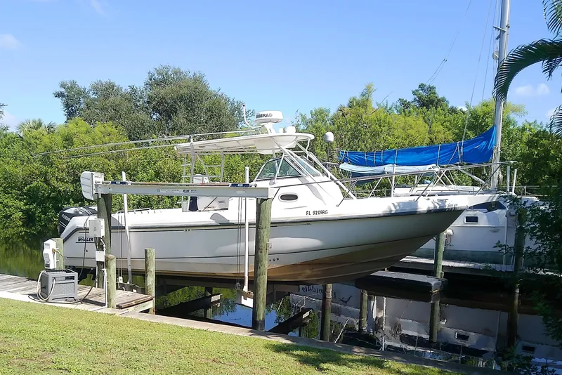 Slide: The Image of 2001 Boston Whaler 28 Outrage boat on trailer, parked in a covered area. - 4