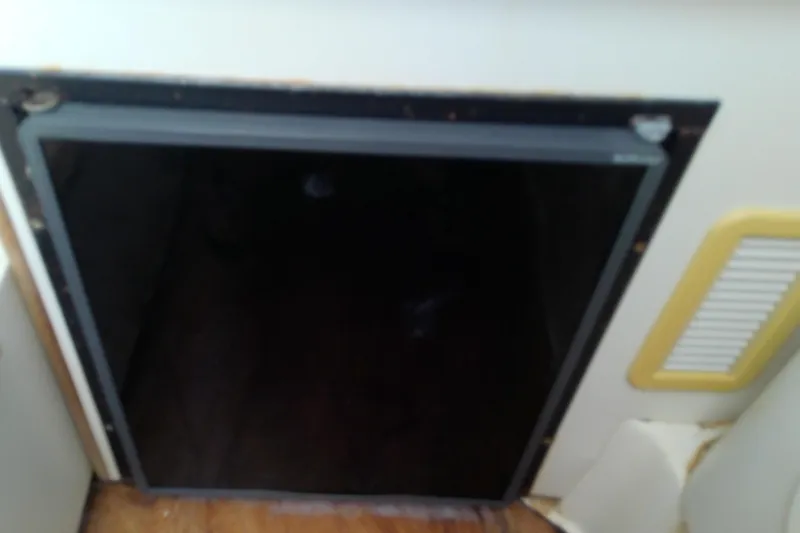 Slide: The Image of Compact kitchen area on 2001 Boston Whaler 28 Outrage boat with stove and sink. - 42