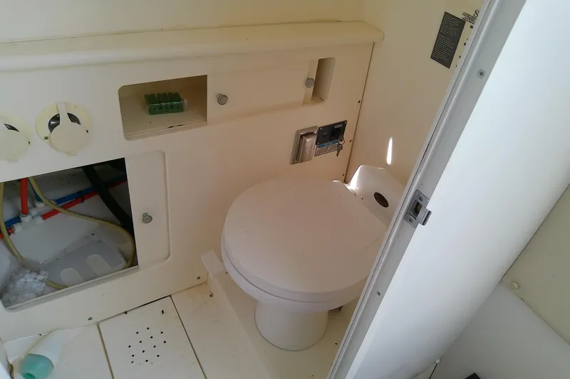 Slide: The Image of 2001 Boston Whaler 28 Outrage boat on lift by a serene canal. - 47