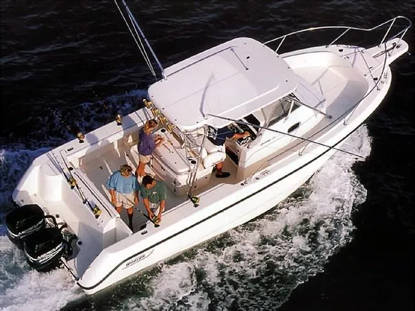 Slide: The Image of 2001 Boston Whaler 28 Outrage boat with dual Mercury 300 engines on a dock lift. - 52