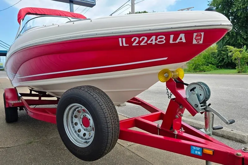 Slide: The Image of 2005 Rinker 192 Captiva BR boat on red trailer, parked on pavement. - 10