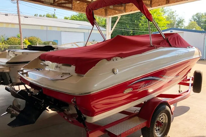 Slide: The Image of 2005 Rinker 192 Captiva BR boat with red cover on trailer in storage. - 12