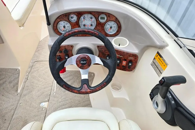 Slide: The Image of 2005 Rinker 192 Captiva BR boat dashboard with steering wheel and control panel. - 13