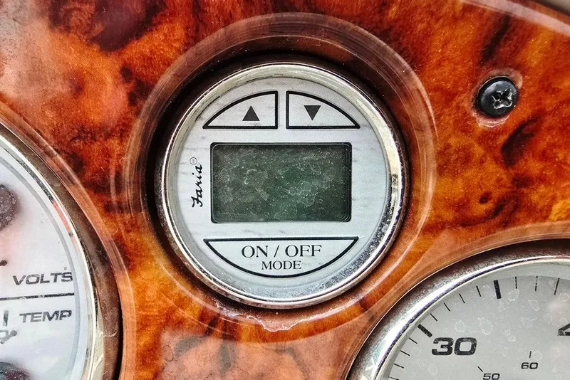 Slide: The Image of Digital display on 2005 Rinker 192 Captiva BR boat dashboard with wood grain finish. - 14