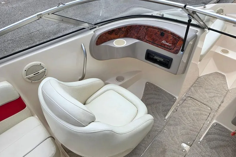 Slide: The Image of 2005 Rinker 192 Captiva BR boat interior with white seating and dashboard details. - 3