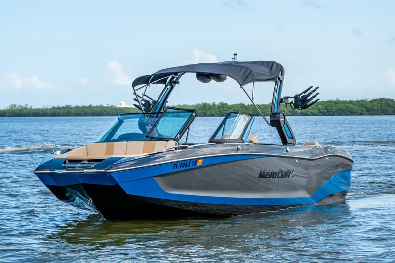 The Image of 2022 MasterCraft X26 boat on calm water, featuring sleek design and modern amenities. - 0