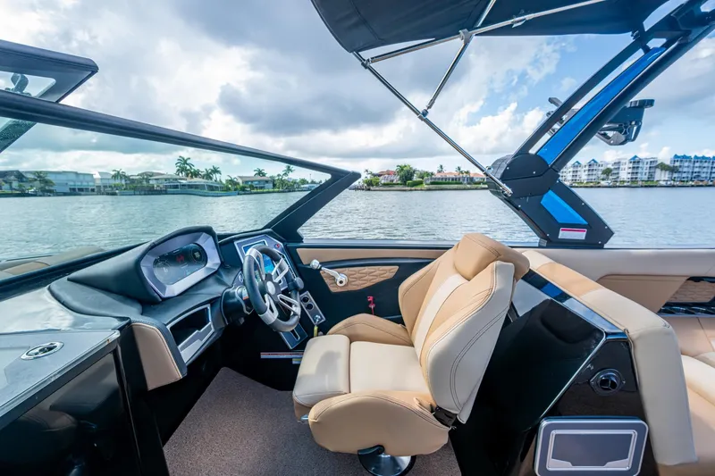 Slide: The Image of Interior of 2022 MasterCraft X26 boat with luxurious seating and modern dashboard. - 19