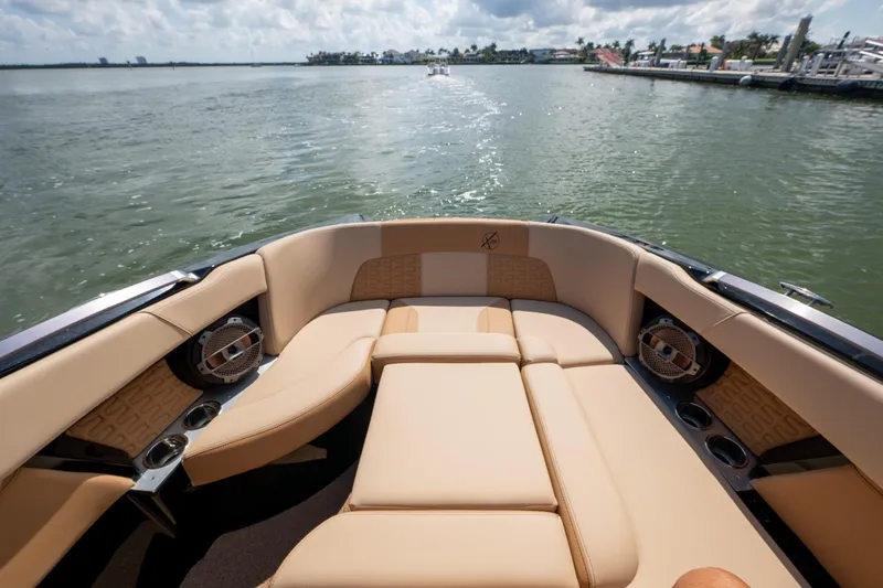 Slide: The Image of Luxurious 2022 MasterCraft X26 boat interior with tan seating on a sunny day. - 20