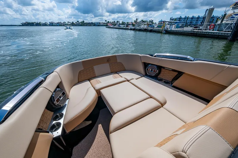 Slide: The Image of Luxurious seating on 2022 MasterCraft X26 boat, docked by a scenic waterfront. - 21