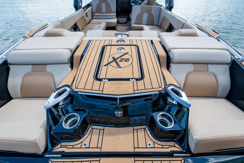 Slide: The Image of 2022 MasterCraft X26 boat interior with luxurious seating and stylish design on the water. - 8