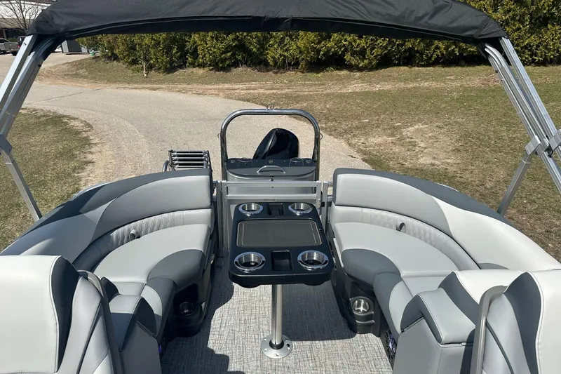 Slide: The Image of 2025 Tahoe 2185 pontoon boat interior with gray seating and cup holders. - 10