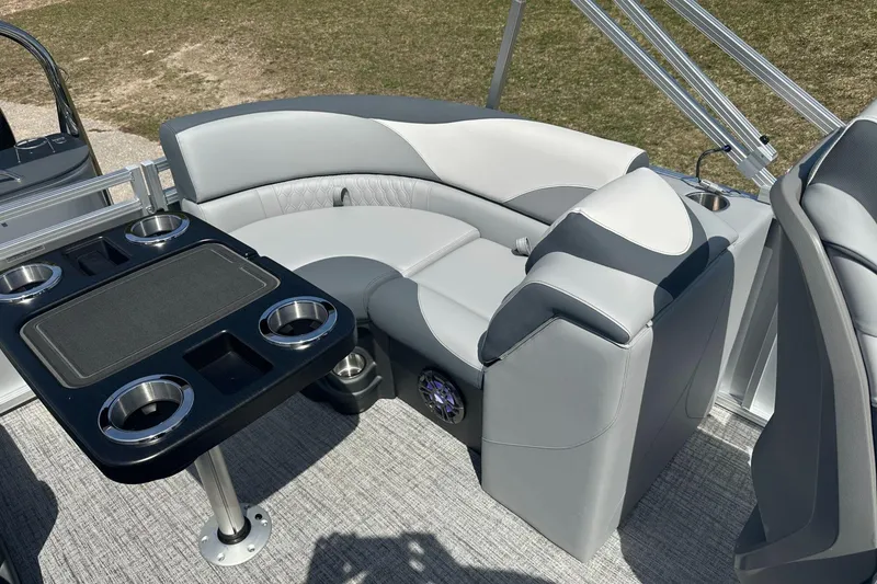 Slide: The Image of Luxurious seating area on 2025 Tahoe 2185 boat with cup holders and table. - 11