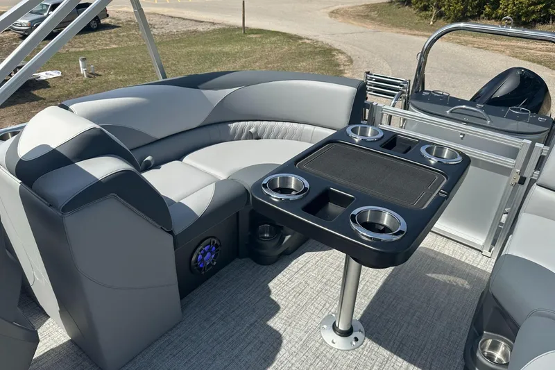 Slide: The Image of Luxurious seating area on 2025 Tahoe 2185 boat with cup holders and table. - 12