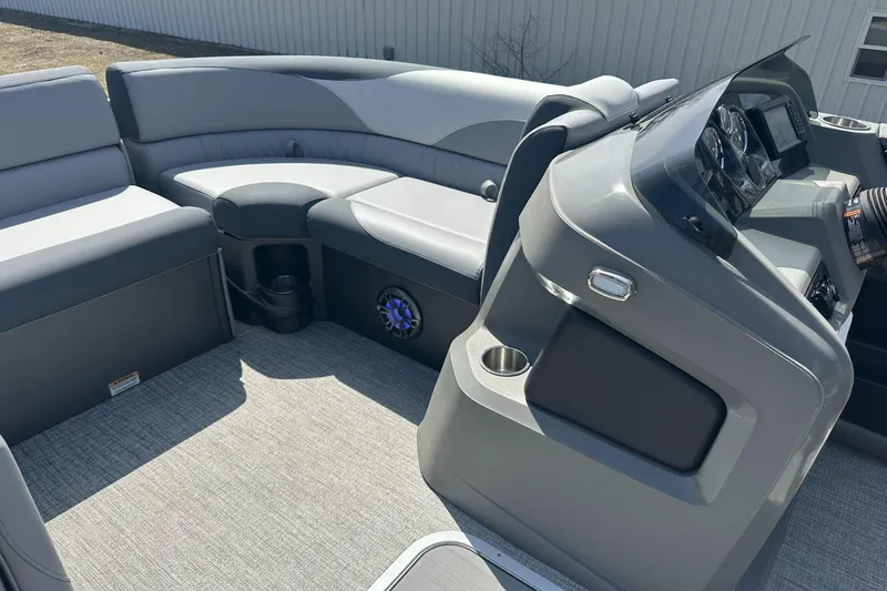 Slide: The Image of 2025 Tahoe 2185 boat interior with gray seating and modern dashboard. - 16