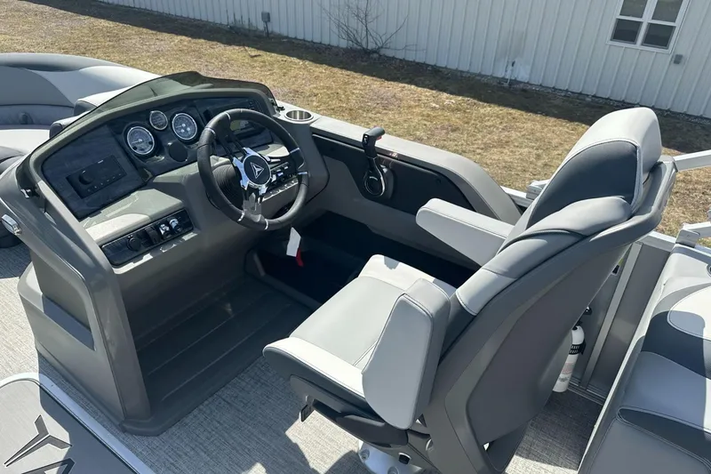 Slide: The Image of 2025 Tahoe 2185 boat cockpit with modern steering and controls, featuring comfortable seating. - 17