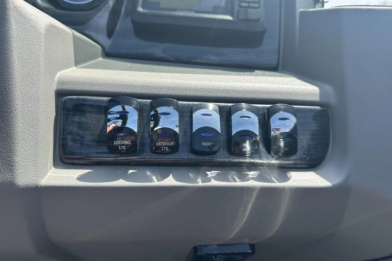 Slide: The Image of Dashboard switches in a 2025 Tahoe 2185, featuring docking and exterior lights controls. - 21