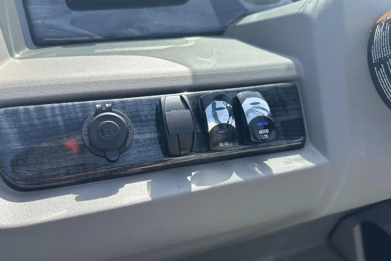 Slide: The Image of Control panel of 2025 Tahoe 2185 with switches and 12V socket. - 22