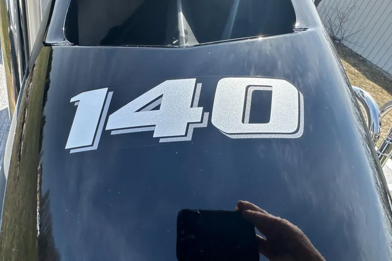 Slide: The Image of Close-up of black Tahoe 2185 boat with '140' decal, 2025 model. - 26