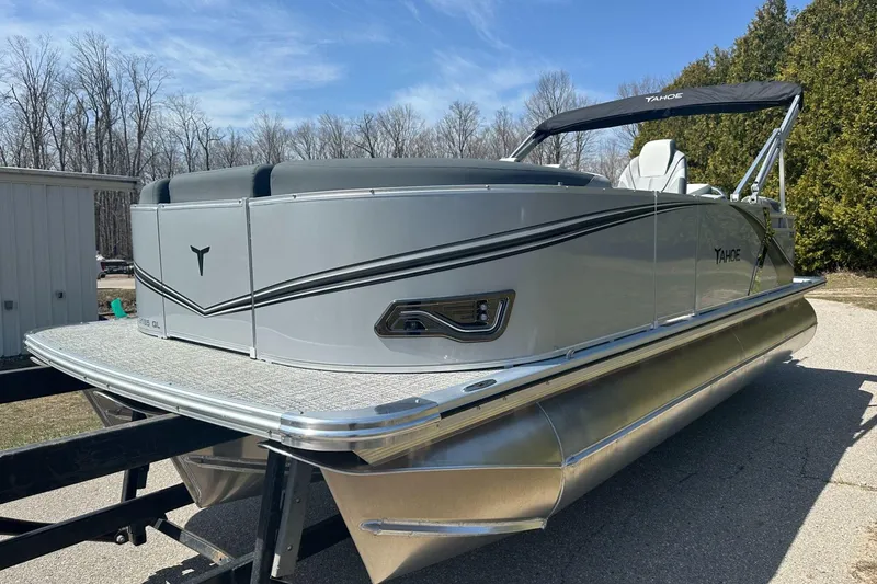 Slide: The Image of 2025 Tahoe 2185 pontoon boat with sleek design, parked outdoors on a sunny day. - 4