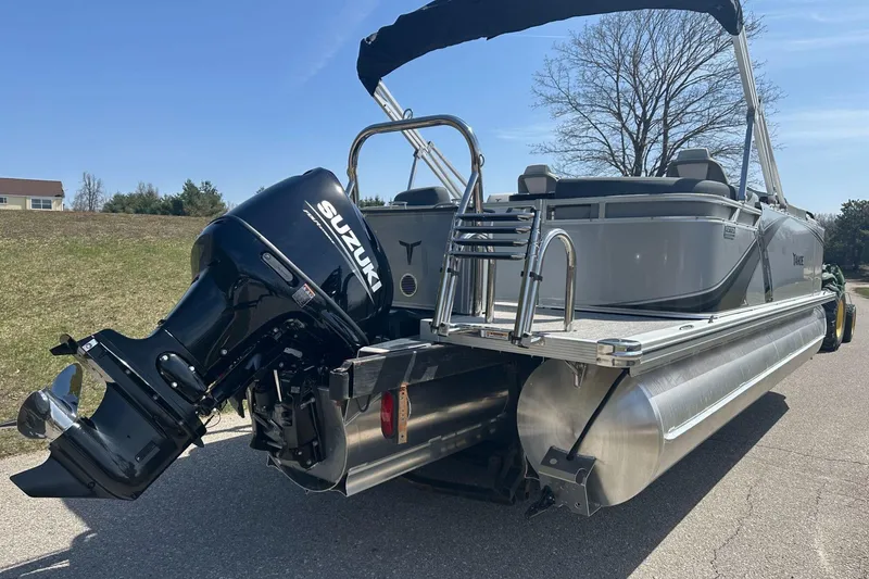 Slide: The Image of 2025 Tahoe 2185 pontoon boat with Suzuki outboard motor on a sunny day. - 8