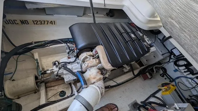 Slide: The Image of Engine compartment of a 2011 Back Cove 30 boat, showcasing mechanical components. - 11