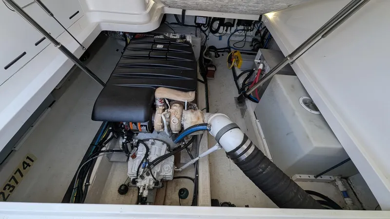 Slide: The Image of Engine compartment of a 2011 Back Cove 30 boat, showcasing mechanical components and wiring. - 12