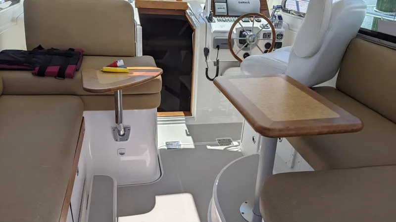 Slide: The Image of Interior of 2011 Back Cove 30 boat with seating and steering wheel. - 5