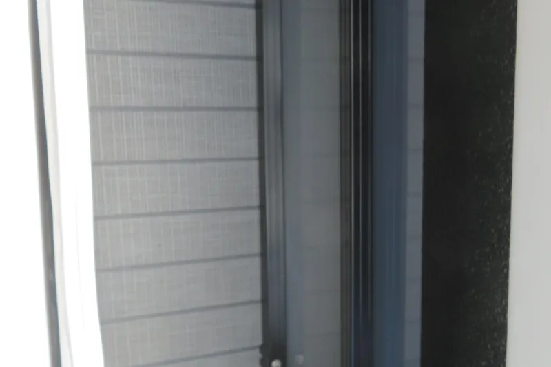 Slide: The Image of Close-up of a modern door with textured glass and sleek black frame. - 50