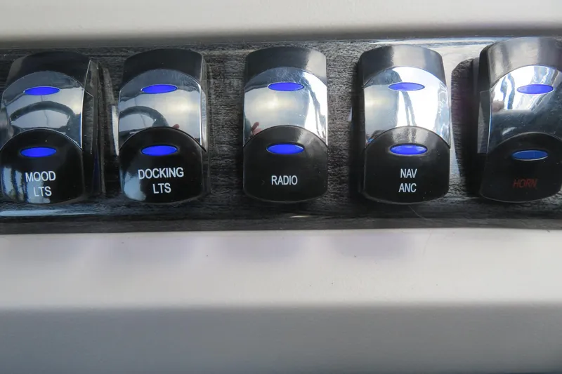Slide: The Image of Control panel switches on 2025 Avalon 2385 LSZ Versatile Rear Lounger boat. - 64